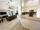 Spacious open-concept kitchen with a breakfast bar, connecting seamlessly to the adjacent living room area at 11301 Via Mari Cae Ct, Clermont, FL 34711
