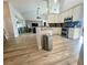 Open concept kitchen with white cabinetry, stainless appliances, and modern finishes at 11301 Via Mari Cae Ct, Clermont, FL 34711