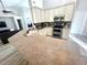 Spacious kitchen with stainless steel appliances, wood grain floors and seating bar at 11301 Via Mari Cae Ct, Clermont, FL 34711