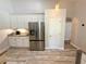 Bright kitchen featuring white cabinets and stainless steel refrigerator at 11301 Via Mari Cae Ct, Clermont, FL 34711