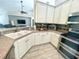 Well-lit kitchen boasts white cabinets, stainless steel appliances, and wood grain floors at 11301 Via Mari Cae Ct, Clermont, FL 34711