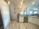 Galley kitchen featuring stainless steel dishwasher and sink with pendant lighting and tiled floors at 11301 Via Mari Cae Ct, Clermont, FL 34711