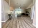 Spacious living room with vaulted ceilings, wood grain floors and lots of natural light at 11301 Via Mari Cae Ct, Clermont, FL 34711