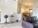 Open living space with modern decor, leading into dining area, with wood grain floors at 11301 Via Mari Cae Ct, Clermont, FL 34711