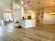 Open-concept living area with wood floors, high ceilings, and great natural light at 11301 Via Mari Cae Ct, Clermont, FL 34711