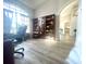 Bright office features wood bookshelves, arched window, and durable flooring at 11301 Via Mari Cae Ct, Clermont, FL 34711