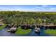 Stunning aerial view of the lake house featuring lush greenery and private boat docks at 12104 Elbert St, Clermont, FL 34711