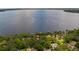Breathtaking aerial view of a waterfront property with a lake and verdant trees at 12104 Elbert St, Clermont, FL 34711