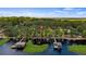 Captivating aerial view of a lakefront property featuring a private dock and lush greenery at 12104 Elbert St, Clermont, FL 34711