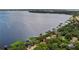 Serene aerial view of a lakefront property with docks surrounded by beautiful scenery at 12104 Elbert St, Clermont, FL 34711
