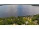 Spectacular aerial view of a lakefront property with a vast lake and verdant surroundings at 12104 Elbert St, Clermont, FL 34711