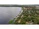 Scenic aerial view of a lakefront property showcasing private docks and lush greenery at 12104 Elbert St, Clermont, FL 34711