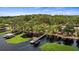 Stunning aerial view of lakefront property with dock, surrounded by lush greenery and mature trees at 12104 Elbert St, Clermont, FL 34711