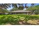 Exterior rear view of the home with a large backyard and covered porch at 12104 Elbert St, Clermont, FL 34711