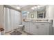 Bathroom featuring a marble vanity top and white cabinets with a shower and toilet in the background at 12104 Elbert St, Clermont, FL 34711