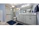 Bright bathroom with double vanity, walk-in shower, and sleek fixtures at 12104 Elbert St, Clermont, FL 34711
