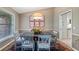 Dining area with seating for six, complemented by floral decor, bright light and framed art at 12104 Elbert St, Clermont, FL 34711