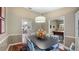 Formal dining room with decorative chairs, adjacent to the kitchen and billiards room at 12104 Elbert St, Clermont, FL 34711