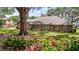 Charming brick home featuring a well-manicured lawn, beautiful landscaping, and an inviting front entrance at 12104 Elbert St, Clermont, FL 34711