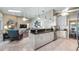 Open kitchen showcasing sleek countertops, white cabinets, and stainless steel appliances at 12104 Elbert St, Clermont, FL 34711