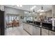 Kitchen with black counters, white cabinets, and view of water and backyard from the dining area at 12104 Elbert St, Clermont, FL 34711