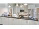 Well-equipped kitchen with white cabinets and stainless steel appliances at 12104 Elbert St, Clermont, FL 34711