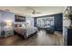 Serene primary bedroom with lake view, sitting area, and hardwood floors at 12104 Elbert St, Clermont, FL 34711