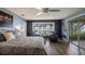 Bright primary bedroom with views of the lake, hardwood floors, and sitting area at 12104 Elbert St, Clermont, FL 34711