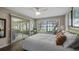 Bright bedroom featuring wood floors, large window with water view, and stylish decor creating a serene space at 12104 Elbert St, Clermont, FL 34711