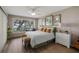 Bright bedroom featuring wood floors, large window with scenic view, and stylish decor creating a serene space at 12104 Elbert St, Clermont, FL 34711