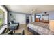 Open primary bedroom with lake views, hardwood floors, sitting area, and television at 12104 Elbert St, Clermont, FL 34711