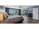 Comfortable primary bedroom featuring lake views, hardwood floors, and sliding door at 12104 Elbert St, Clermont, FL 34711