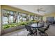 Inviting screened patio with tile flooring, ceiling fans, and stunning lake views at 12104 Elbert St, Clermont, FL 34711