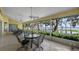 Enclosed patio with tile floor, ceiling fans, and picturesque waterfront scenery at 12104 Elbert St, Clermont, FL 34711