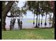 Scenic waterfront with a dock and lush green lawn at 12104 Elbert St, Clermont, FL 34711