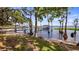 Picturesque waterfront view with a private dock, sandy beach area, and tranquil waters, perfect for recreation at 12104 Elbert St, Clermont, FL 34711