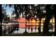 Stunning waterfront view with a dock and a beautiful sunset at 12104 Elbert St, Clermont, FL 34711