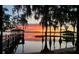 Serene waterfront view at sunset with a dock at 12104 Elbert St, Clermont, FL 34711