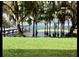 Lush green lawn leading to a waterfront with a dock and rainbow at 12104 Elbert St, Clermont, FL 34711