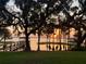 Picturesque waterfront view with a dock and a sunset, framed by mature trees draped with Spanish moss at 12104 Elbert St, Clermont, FL 34711