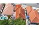 Aerial view of a home with a red tile roof, outdoor patio, and screened pool enclosure at 1305 Santa Maria Ave, The Villages, FL 32159
