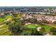 High altitude aerial showing a neighborhood adjacent to the golf course with water views at 1305 Santa Maria Ave, The Villages, FL 32159