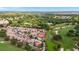 Aerial view overlooking the golf course and neighborhood surrounded by nature at 1305 Santa Maria Ave, The Villages, FL 32159