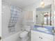Bathroom featuring a tub with shower and a vanity with a blue countertop at 1305 Santa Maria Ave, The Villages, FL 32159