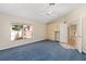 Bright bedroom featuring a ceiling fan, storage cabinets, a window, and a door leading to another room at 1305 Santa Maria Ave, The Villages, FL 32159