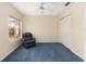 Cozy bedroom features plush carpet, a ceiling fan and bright window views at 1305 Santa Maria Ave, The Villages, FL 32159