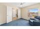 Comfortable bedroom with plush carpet, bright windows, and a ceiling fan at 1305 Santa Maria Ave, The Villages, FL 32159
