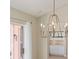 A dining area with sliding glass doors, sheer curtains and a chandelier at 1305 Santa Maria Ave, The Villages, FL 32159