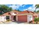 Charming single-Gathering home featuring a red tile roof, landscaped front yard, and attached two-car garage at 1305 Santa Maria Ave, The Villages, FL 32159