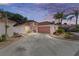 Charming home boasting a well-manicured lawn and driveway leading to a two-car garage at 1305 Santa Maria Ave, The Villages, FL 32159